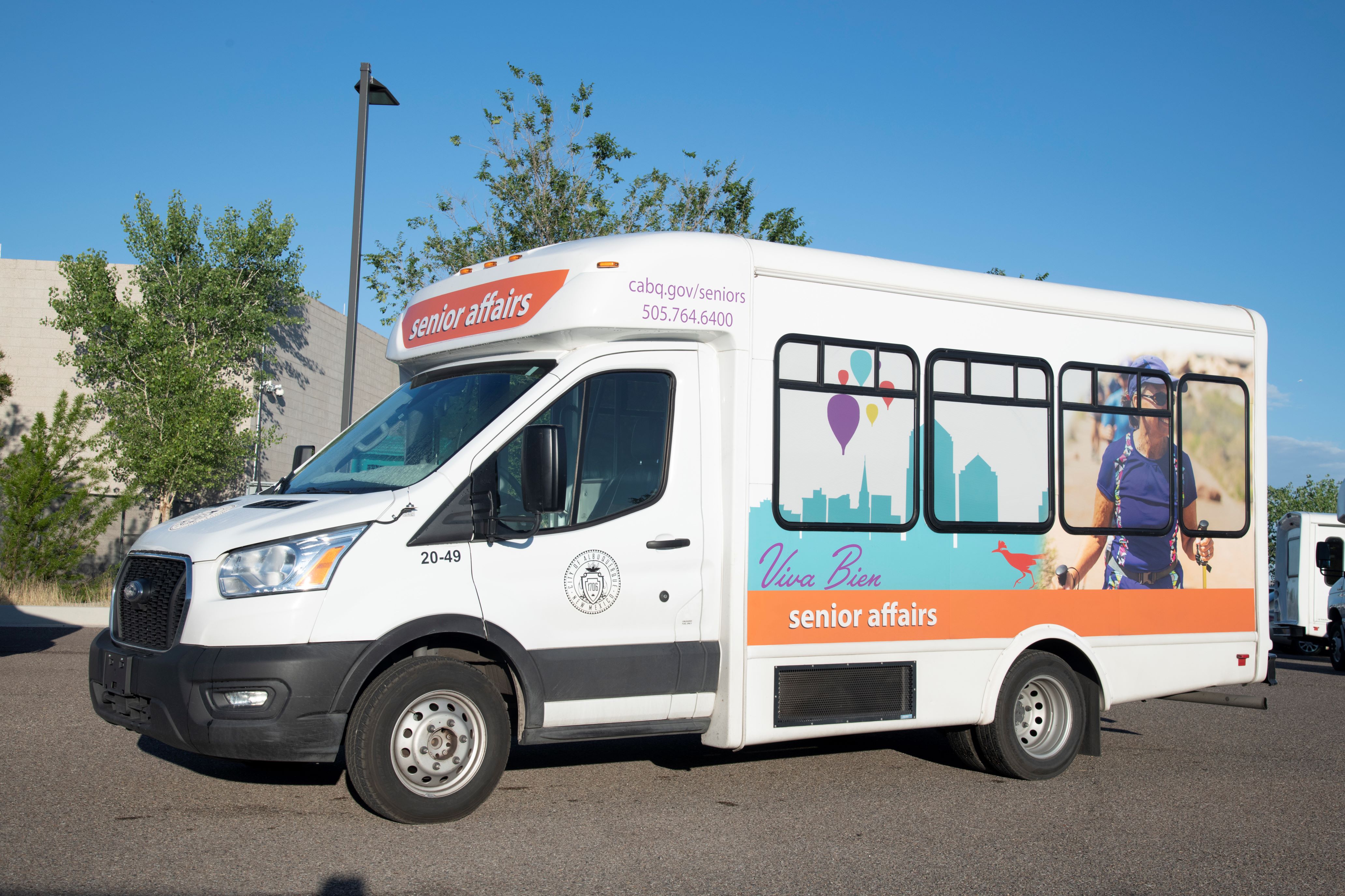 A Masked Senior Affairs Services Staff Member Driving a City Van