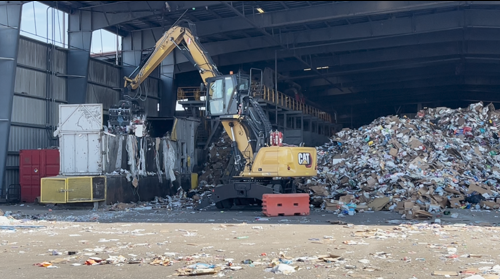 Material Handler loads recyclable material into the recycling process.