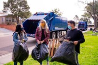 People Carrying Bags of Trash in Park People Carrying Bags of Trash in Park