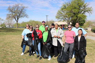 Group of people holding trashbags and smiling during One ABQ Cleanup Day!