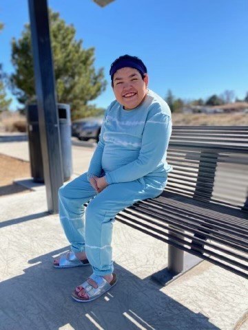 Genevieve "Genny" Jo Barrera sitting on a bench.