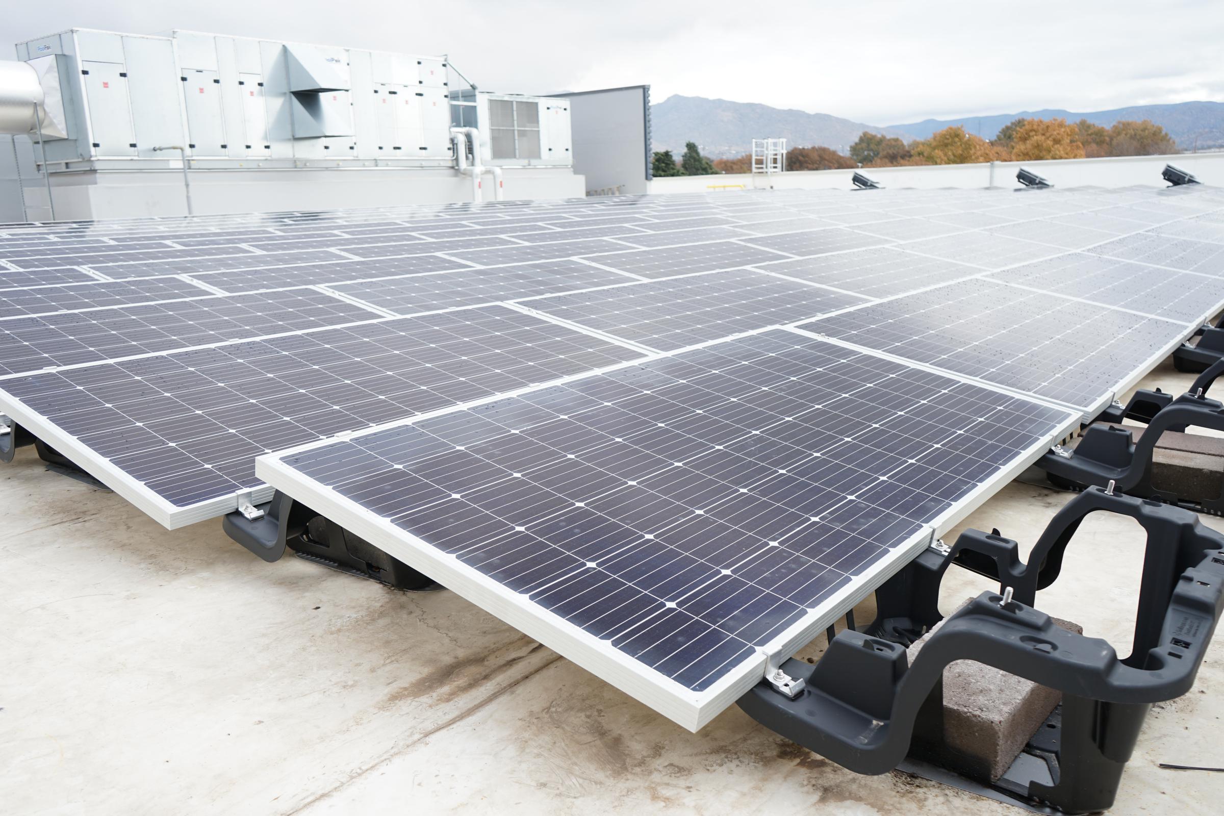 Solar panels under a sunset