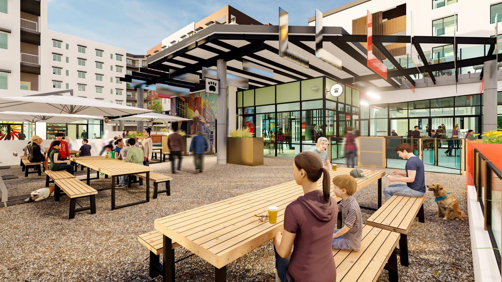 Commercial and recreational piece of Uptown Connect development featuring community members sitting in the outdoor patio of the food court and experiencing all that the complex has to offer including connectivity to transit, housing, and fun activities to do in Uptown.
