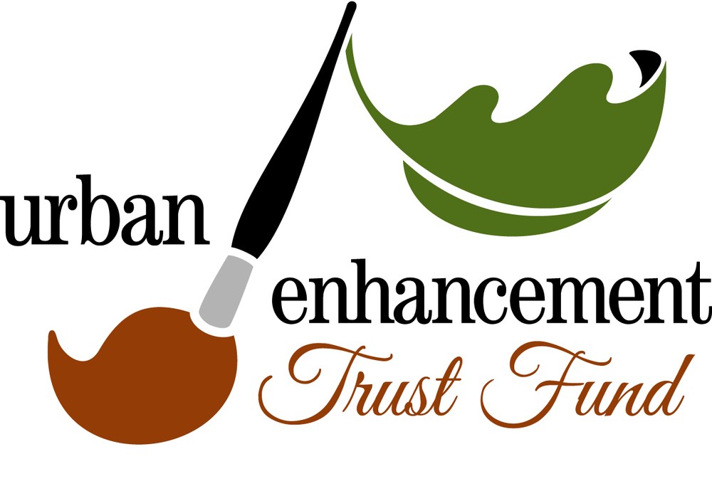 Image of a paintbrush with a leaf at the top and text that reads "Urban Enhancement Trust Fund."